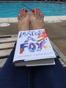 Reading a book in summer by the pool