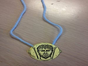 Janus token necklace made by students